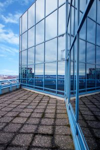 Exterior shot of the 16th floor boardroom balcony with the blue skies reflecting in the windows overlooking the city